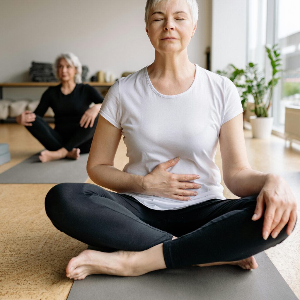 pexels photo 8436729 8436729 Elderly women practicing yoga indoors for health and wellness.