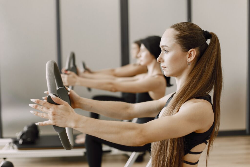 pexels photo 8769177 8769177 Women performing pilates exercises with magic rings, focusing on fitness and healthy lifestyle.